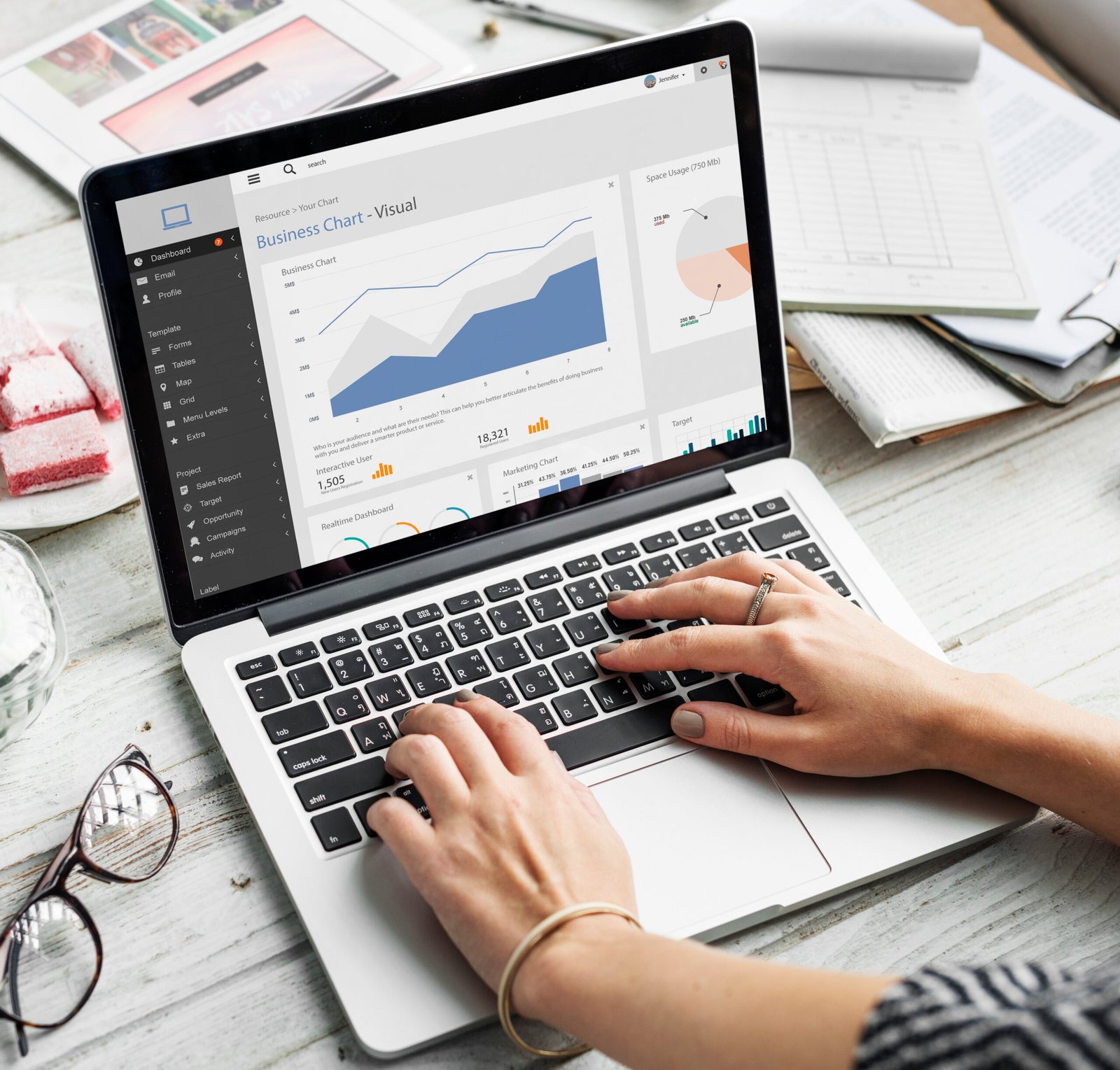 WPDPS managed website owner analyzing Core Web Vitals metrics on a custom performance dashboard on their laptop. Illustrated by hands with a ring and bracelet.